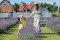 Family portrait in lavender field, mother and daughter together having fun