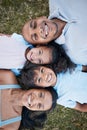 Family, portrait and lying on grass in garden with mother, father and kids together with love. Face, top view and dad Royalty Free Stock Photo