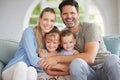 Family portrait, man and woman with children bonding in house living room, home interior and lounge sofa. Happy smile Royalty Free Stock Photo