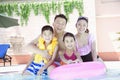 Family portrait, mother, father, daughter, and son, smiling by the pool Royalty Free Stock Photo