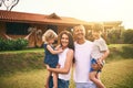 Family, portrait and new home with father, mother and kids with happiness and love. Outdoor, happy and lens flare of a Royalty Free Stock Photo
