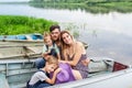 Family portrait of parents with children in the boat on the beautiful lake. Royalty Free Stock Photo