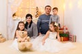 Family portrait - parents and children in home interior decorated with holiday lights and gifts Royalty Free Stock Photo