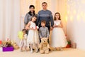 Family portrait - parents and children in home interior decorated with holiday lights and gifts Royalty Free Stock Photo