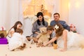 Family portrait - parents and children in home interior decorated with holiday lights and gifts Royalty Free Stock Photo