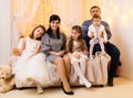 Family portrait - parents and children in home interior decorated with holiday lights and gifts Royalty Free Stock Photo