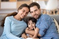 Family portrait of parents posing at home with little daughter Royalty Free Stock Photo