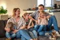 family portrait. family photo in which mom, dad, daughters, son and dog are smiling and hugging on the couch in a cozy Royalty Free Stock Photo