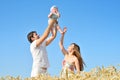 Family portrait. Picture of happy loving father, mother and their baby outdoors. Daddy, mom and child against summer blue sky. Royalty Free Stock Photo