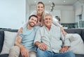 Family, portrait and relax on sofa in living room, smiling and bonding. Love, care and happy man, woman and grandfather Royalty Free Stock Photo