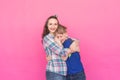 Family portrait sister and teenager brother on pink background