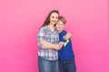 Family portrait sister and teenager brother on pink background