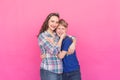 Family portrait sister and teenager brother on pink background