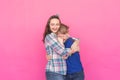 Family portrait sister and teenager brother on pink background