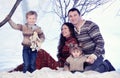 Family portrait sits on studio snow forest background Royalty Free Stock Photo