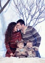 Family portrait sits on studio snow forest background Royalty Free Stock Photo