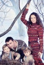 Family portrait sits on studio snow forest background Royalty Free Stock Photo