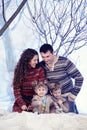 Family portrait sits on studio snow forest background Royalty Free Stock Photo