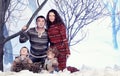 Family portrait sits on studio snow forest background Royalty Free Stock Photo