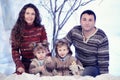 Family portrait sits on studio snow forest background Royalty Free Stock Photo