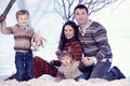 Family portrait sits on studio snow forest background Royalty Free Stock Photo