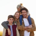 Family, portrait and smile with countryside, walk and sunrise for morning exercise and bond. Parents, children and field Royalty Free Stock Photo