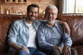 Family portrait smiling mature father and grownup son hugging Royalty Free Stock Photo