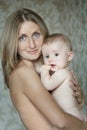 Family portrait of smiling mother holding her baby child Royalty Free Stock Photo