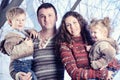 Family portrait standing on studio snow forest background Royalty Free Stock Photo