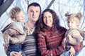 Family portrait standing on studio snow forest background Royalty Free Stock Photo