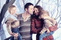 Family portrait standing on studio snow forest background Royalty Free Stock Photo