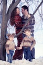 Family portrait standing on studio snow forest background Royalty Free Stock Photo