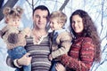 Family portrait standing on studio snow forest background Royalty Free Stock Photo