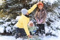 family portrait in the winter forest  mother and children sitting and playing with snow  beautiful nature with snowy fir trees Royalty Free Stock Photo
