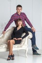 Family portrait of young couple sitting on a couch Royalty Free Stock Photo