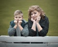 Family portrait young pretty mother and teenager son looking at camera in city park Royalty Free Stock Photo