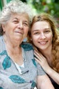 Family portrait of young woman and her grandmother Royalty Free Stock Photo