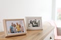 Family portraits in frames on cabinet