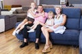 Family posing near new sofa