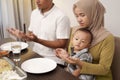 Family pray before having dinner together Royalty Free Stock Photo