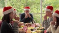 The family is praying for Christmas before dinner.Christmas day concept, family day