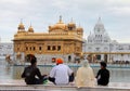 A family praying in front of golden temple Royalty Free Stock Photo