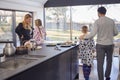 Family Preparing Brunch At Home In Modern Kitchen Together Royalty Free Stock Photo