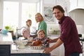 Family Preparing Roast Turkey Meal In Kitchen Together Royalty Free Stock Photo