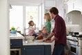 Family Preparing Roast Turkey Meal In Kitchen Together Royalty Free Stock Photo