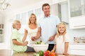 Family Preparing Salad In Modern Kitchen Royalty Free Stock Photo