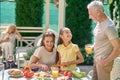 Family preparing for the thanksgiving dinner and looking involved Royalty Free Stock Photo