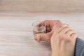 Family problem - alcoholism: a shot of vodka battered men, the hand of the woman holds the man`s hand, forbidding to drink alcoho Royalty Free Stock Photo