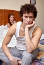 Family conflict. Young couple quarrels in bedroom at home.  Selective focus on woman Royalty Free Stock Photo