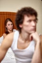 Family conflict. Young couple quarrels in bedroom at home.  Selective focus on woman Royalty Free Stock Photo